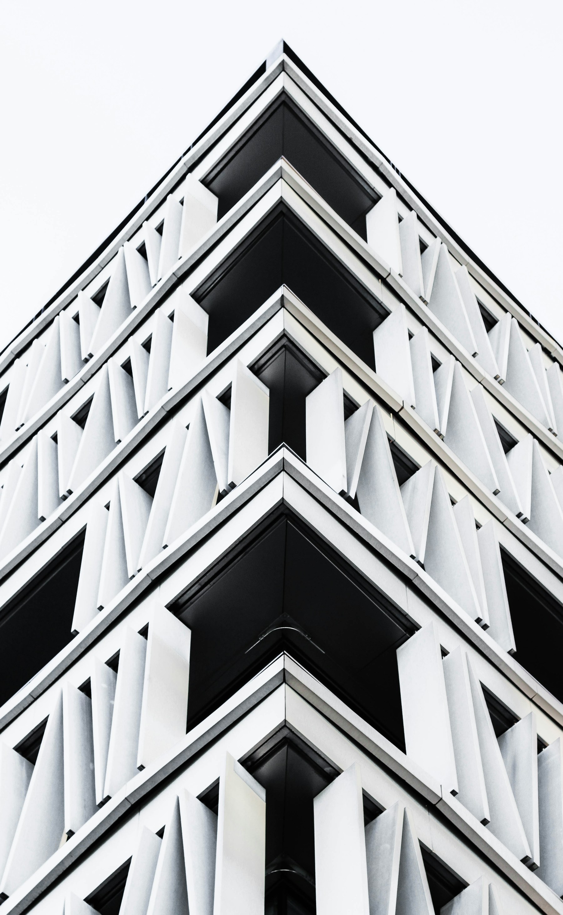 Monochromatyczna fotografia geometrycznej fasady wieżowca